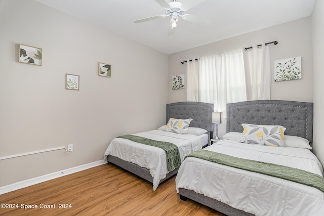 bedroom with ceiling fan and hardwood / wood-style floors