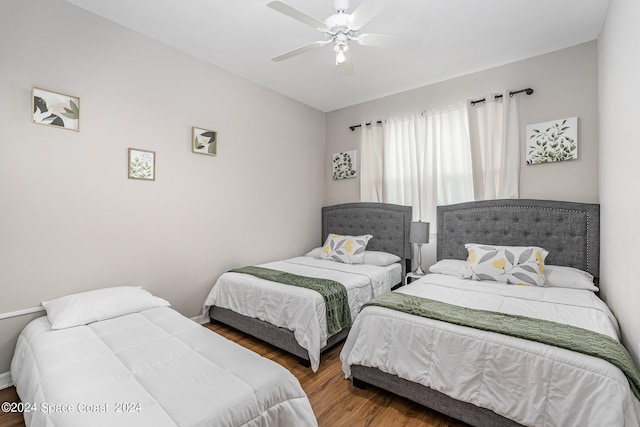 bedroom with ceiling fan and wood-type flooring