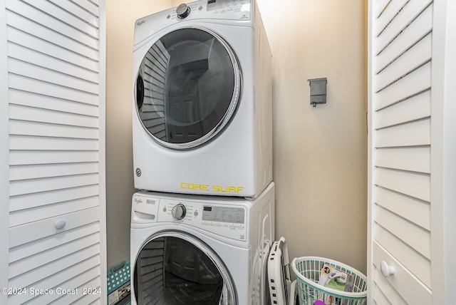 laundry area featuring stacked washer / drying machine