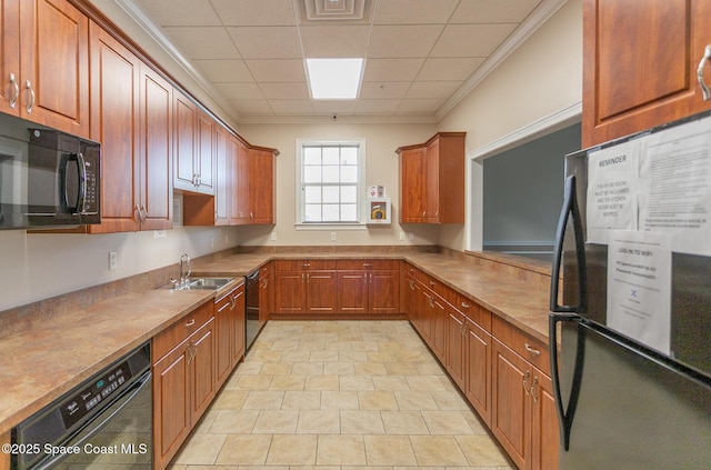 560 Remington Green Dr SE Unit 103, Palm Bay, FL 32909 - kitchen featuring a sink, brown cabinetry, black appliances, and a paneled ceiling