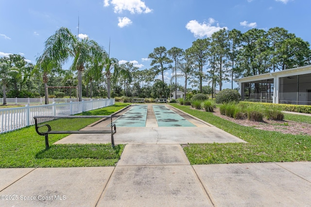 560 Remington Green Dr SE Unit 103, Palm Bay, FL 32909 - view of property's community featuring a yard, shuffleboard, and fence
