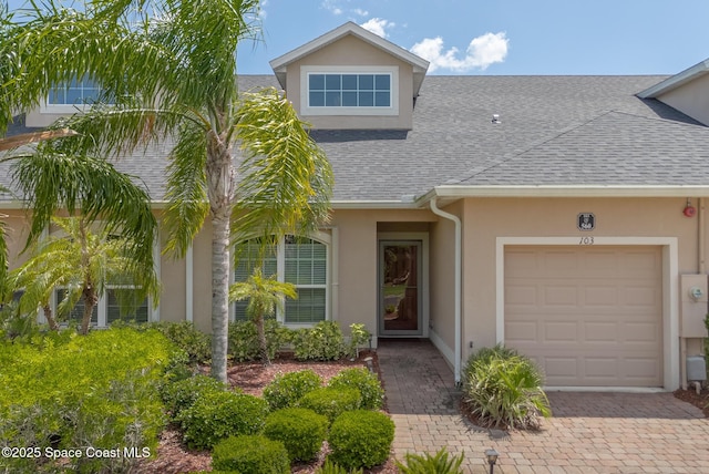 560 Remington Green Dr SE Unit 103, Palm Bay, FL 32909 - multi unit property featuring an attached garage, roof with shingles, stucco siding, and decorative driveway