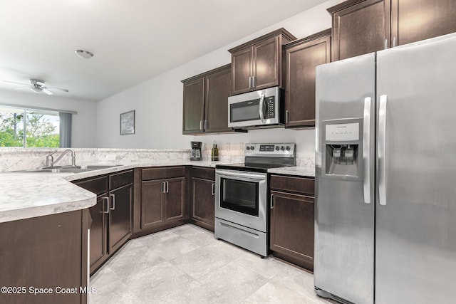 560 Remington Green Dr SE Unit 103, Palm Bay, FL 32909 - kitchen featuring a sink, light countertops, appliances with stainless steel finishes, ceiling fan, and dark brown cabinetry