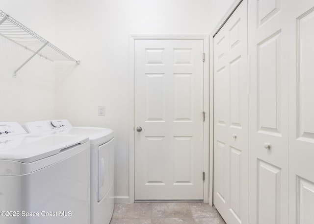 560 Remington Green Dr SE Unit 103, Palm Bay, FL 32909 - clothes washing area featuring laundry area, baseboards, and washing machine and dryer