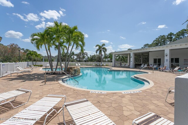 560 Remington Green Dr SE Unit 103, Palm Bay, FL 32909 - community pool featuring a patio area and fence