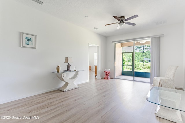 560 Remington Green Dr SE Unit 103, Palm Bay, FL 32909 - living area with visible vents, baseboards, a ceiling fan, and wood finished floors