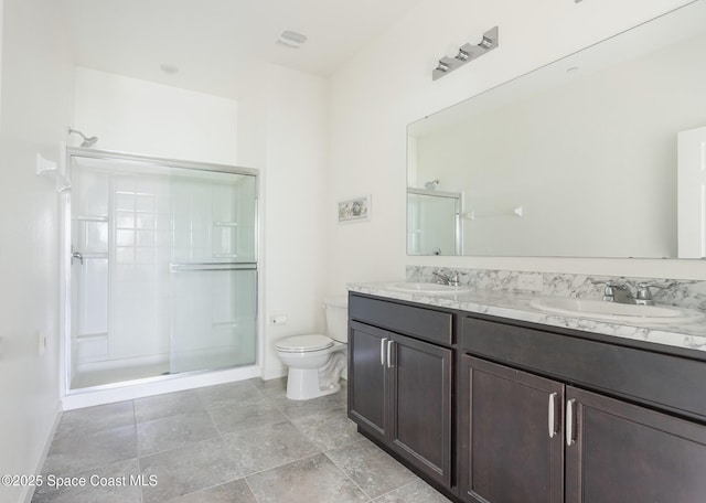 560 Remington Green Dr SE Unit 103, Palm Bay, FL 32909 - bathroom featuring a sink, toilet, double vanity, and a stall shower