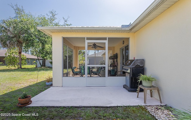 view of patio / terrace featuring grilling area, a sunroom, and ceiling fan