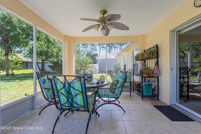 sunroom with ceiling fan and a healthy amount of sunlight