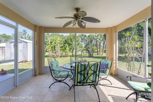 sunroom / solarium with ceiling fan, a healthy amount of sunlight, and outdoor dining space