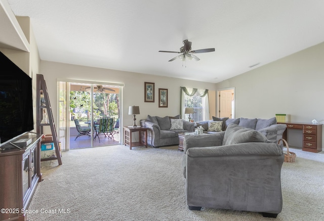 carpeted living room with vaulted ceiling, a wealth of natural light, a ceiling fan, and visible vents