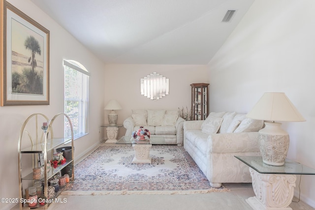 living room featuring lofted ceiling, baseboards, visible vents, and a notable chandelier
