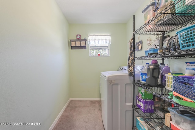 clothes washing area featuring separate washer and dryer, baseboards, laundry area, and carpet flooring