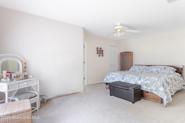 carpeted bedroom featuring baseboards and ceiling fan