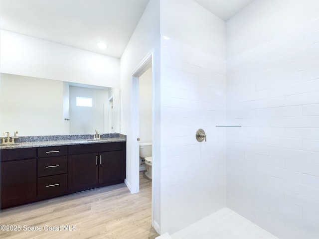 bathroom with hardwood / wood-style flooring, toilet, and vanity