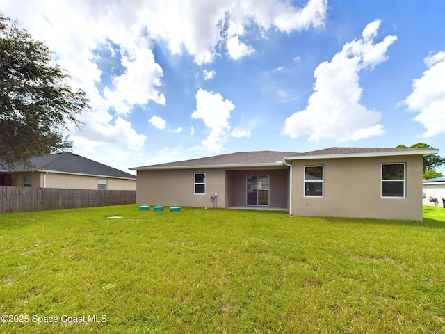 rear view of property with a lawn