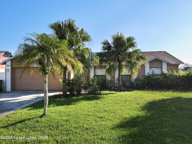 view of front of property with a garage and a front lawn