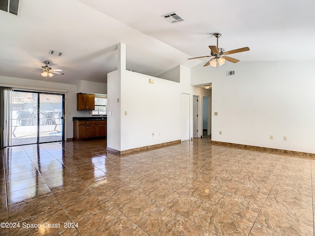 unfurnished living room featuring ceiling fan, high vaulted ceiling, and tile patterned floors