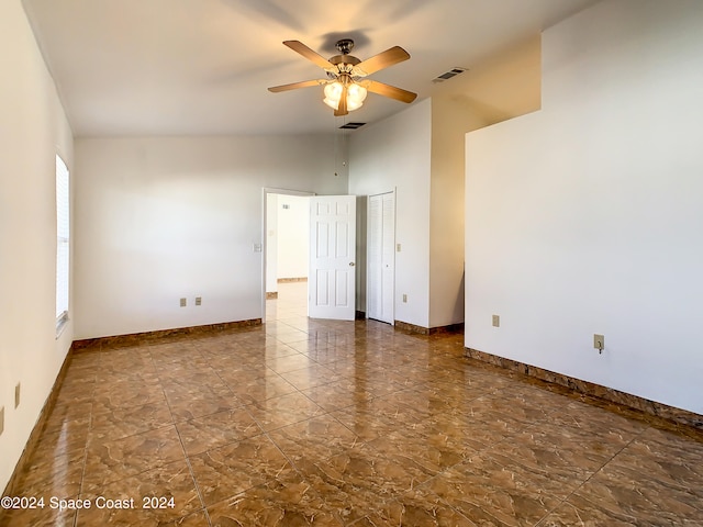 tiled spare room featuring ceiling fan and high vaulted ceiling