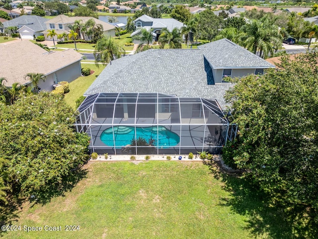 view of pool with a lanai and a yard