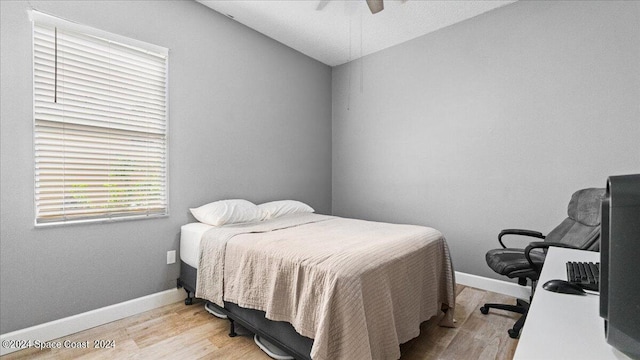 bedroom featuring light wood-type flooring and ceiling fan