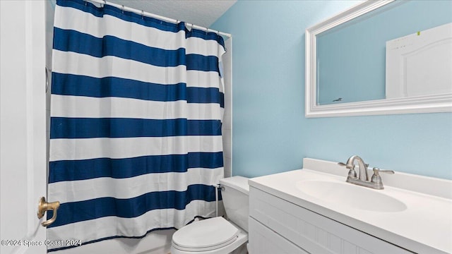 bathroom with a textured ceiling, vanity, toilet, and a shower with curtain