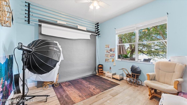 living area featuring ceiling fan and light hardwood / wood-style flooring