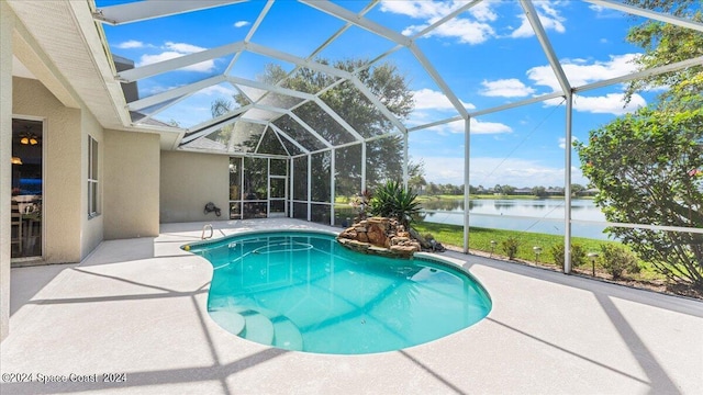 view of swimming pool featuring a lanai, a water view, and a patio area