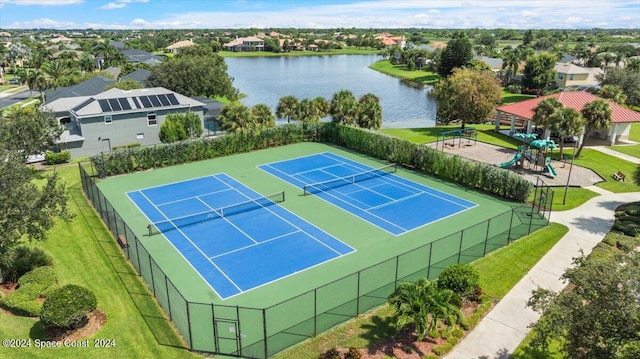 view of tennis court featuring a water view