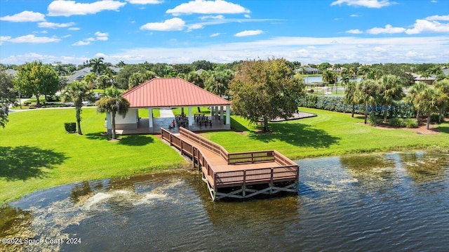 view of dock featuring a gazebo, a yard, and a water view