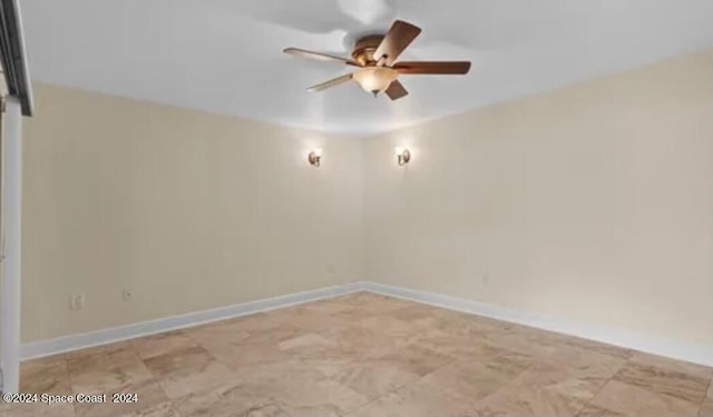 spare room featuring ceiling fan and light tile patterned flooring