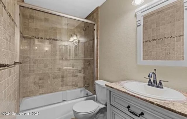 full bathroom with vanity, toilet, and enclosed tub / shower combo