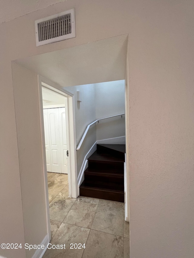 stairs featuring tile patterned flooring