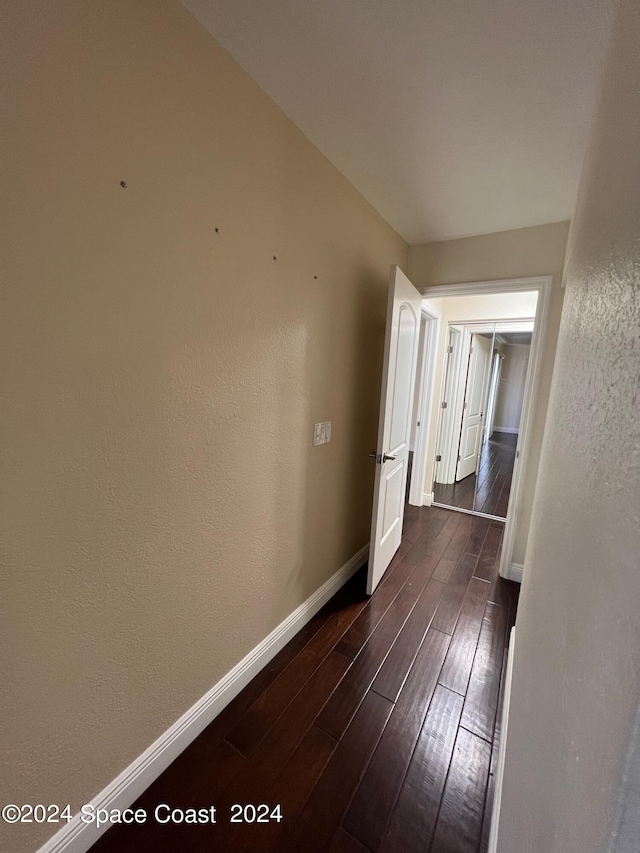 hallway featuring dark wood-type flooring