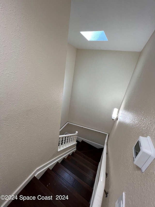 staircase featuring a skylight