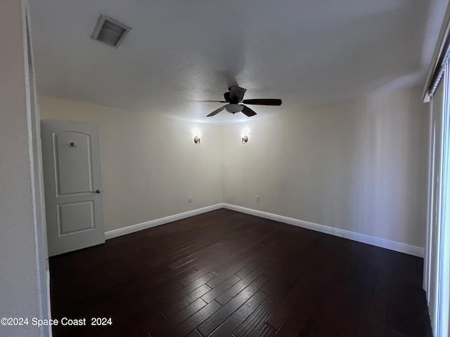 spare room with ceiling fan and dark hardwood / wood-style floors