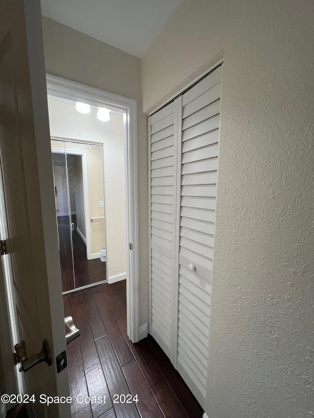 hall with dark hardwood / wood-style flooring