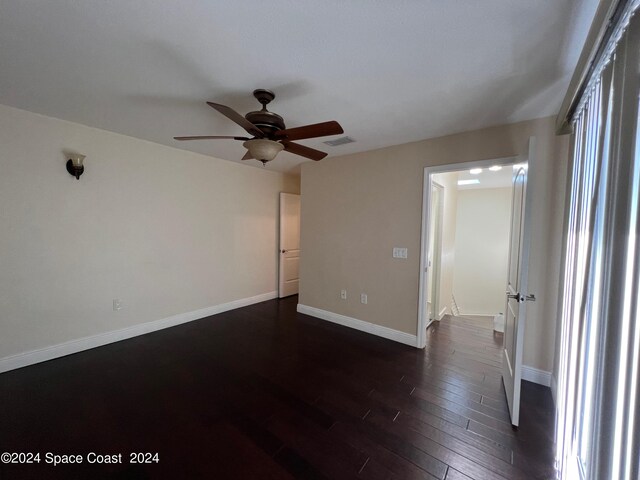 unfurnished room with ceiling fan and dark hardwood / wood-style floors