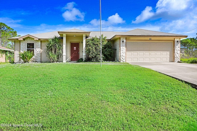 ranch-style home with a front yard and a garage