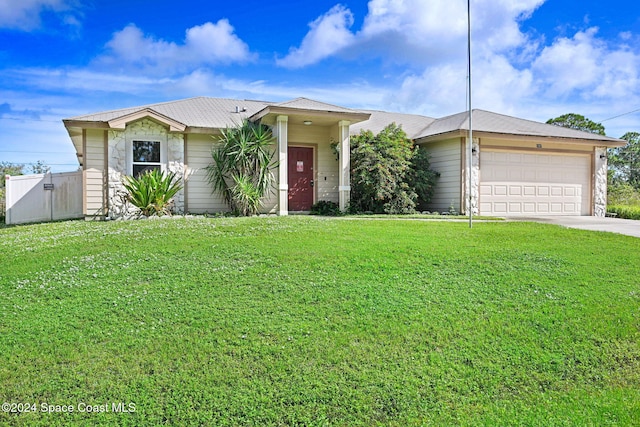 single story home with a front yard and a garage