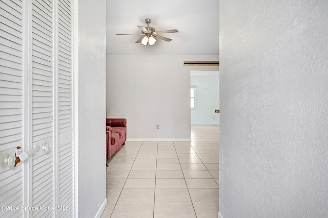 hall featuring light tile patterned flooring