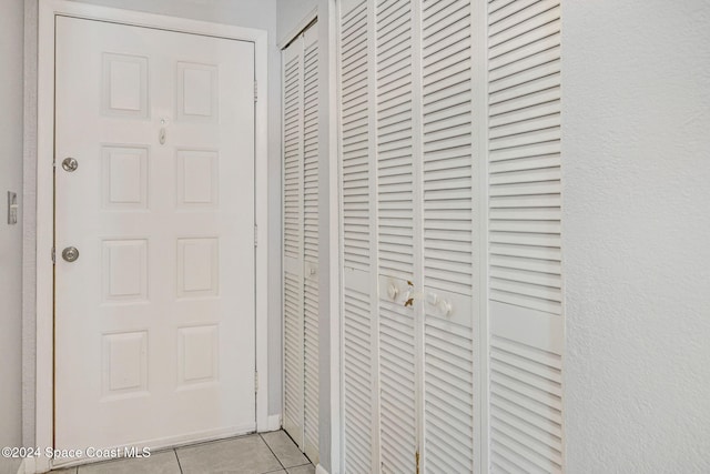 hallway featuring light tile patterned floors