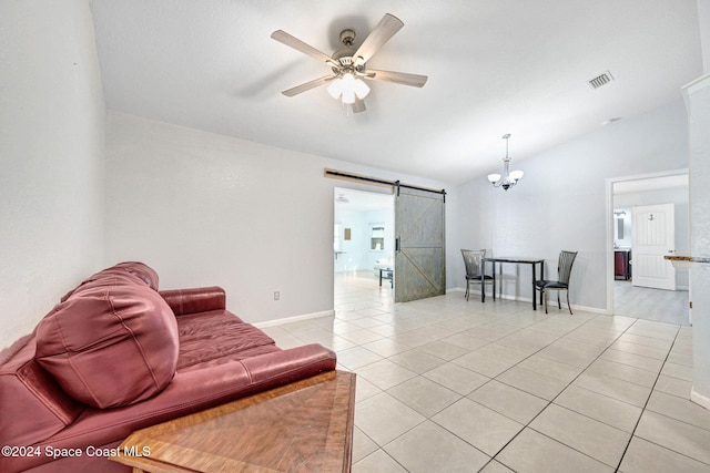 tiled living room with lofted ceiling, a barn door, and ceiling fan