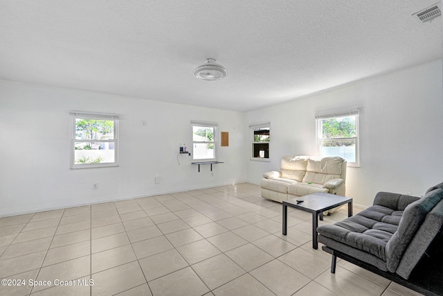 living room featuring a textured ceiling and light tile patterned flooring