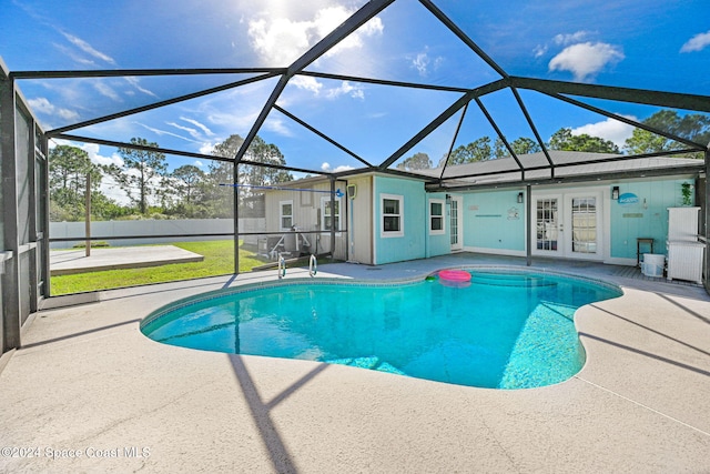 view of pool with a lanai, french doors, and a patio area