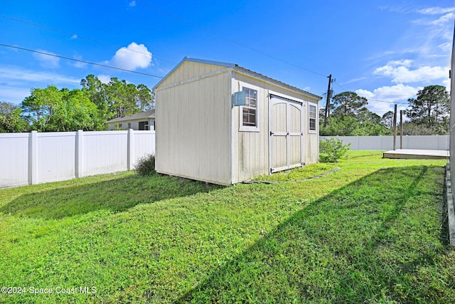 view of outbuilding featuring a lawn