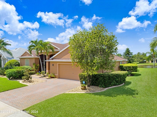 view of front facade with a front lawn and a garage