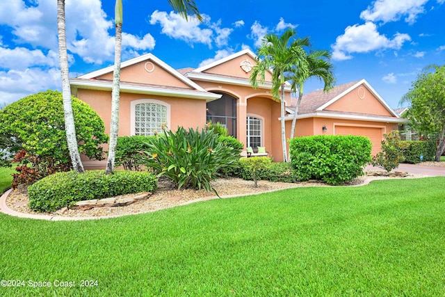 view of front of house with a front lawn and a garage