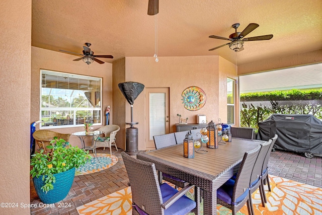 view of patio / terrace with ceiling fan and a grill