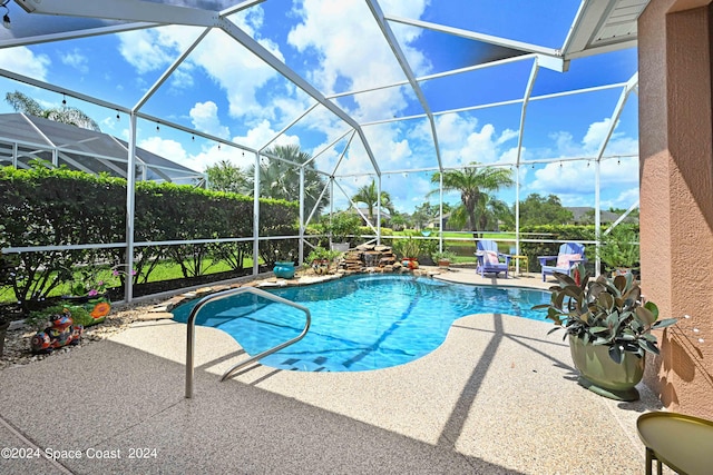 view of pool with a lanai and a patio